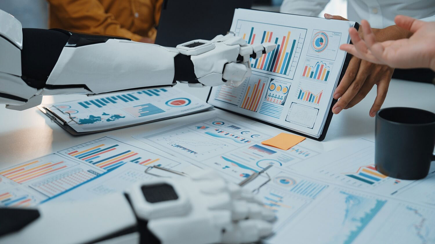 Robotic arm analyzing data charts